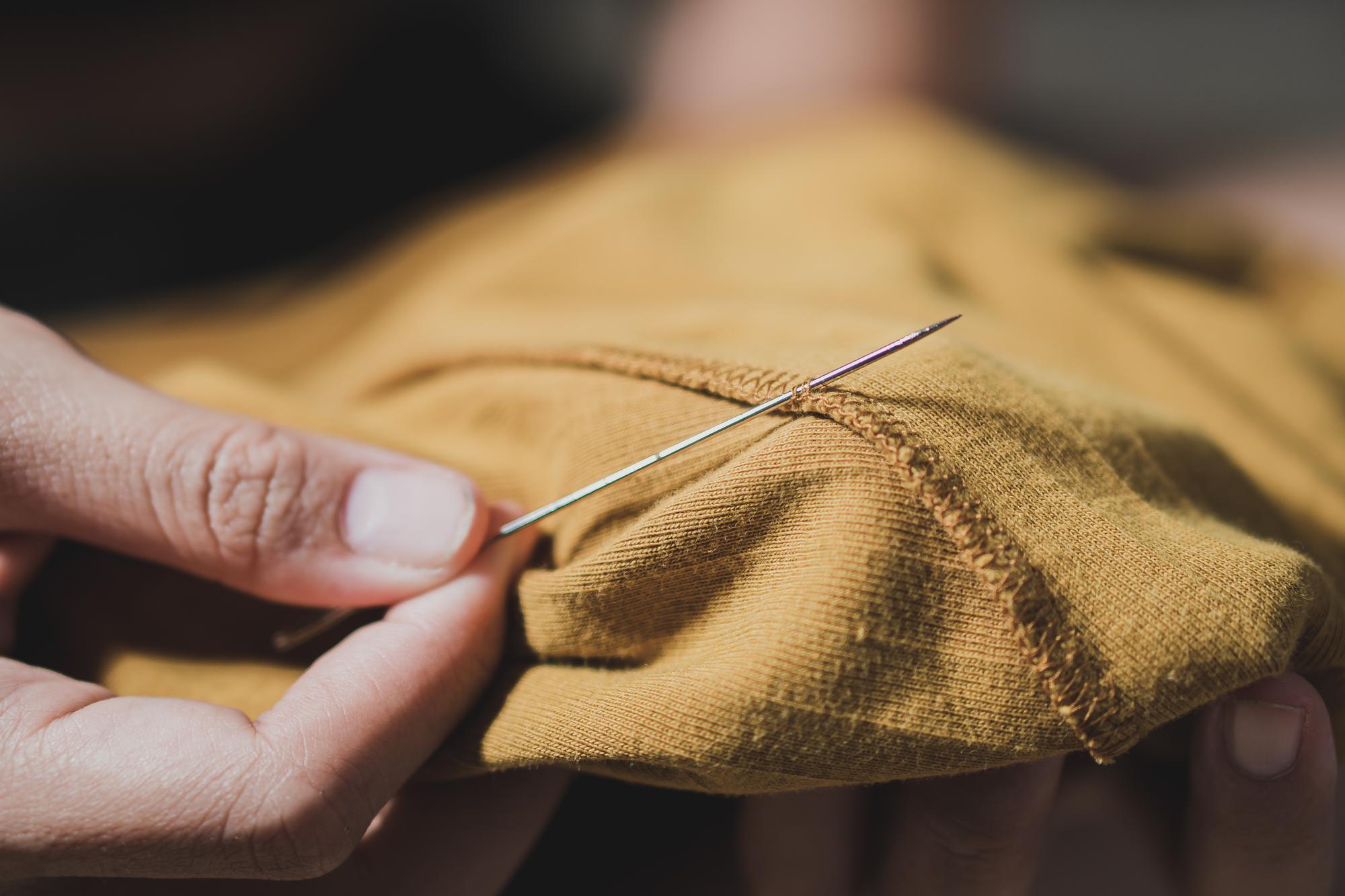 Artisan stitching hands with linen